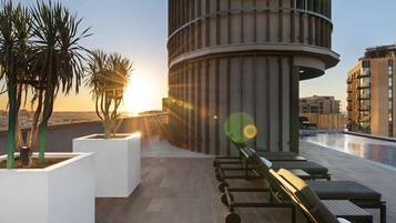 Outdoor pool, open 8:00 AM to 8:00 PM, pool umbrellas