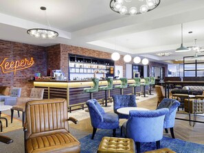 A bar area with a neon sign, green bar stools, and a brick wall. - ibis Bridgwater (Bridgwater)