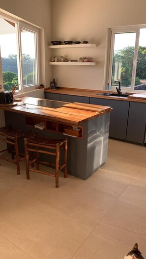 Dishwasher, toaster, dining tables, kitchen islands