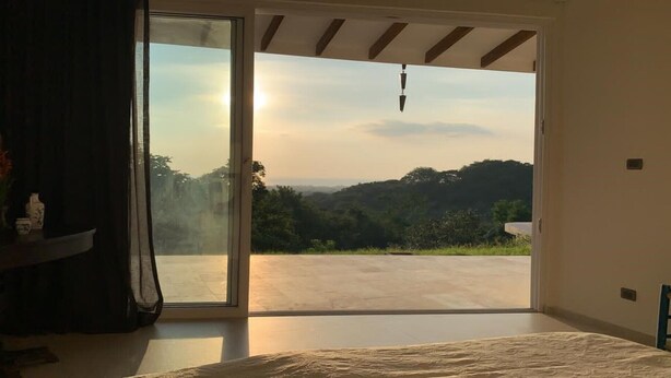 A bedroom with a large sliding glass door leading to an outdoor patio. - House with terrace and pool. (Playa Negra Finca Los Pargos)