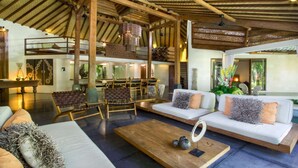 A spacious, well-lit interior with high ceilings, wooden beams, and a dining area with a view of the outdoors. - 5 Star Villa in Bali, Minutes from the Beach, Bali Villa 2065 (Bali)