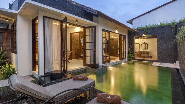 A modern villa with a swimming pool, a covered outdoor seating area, and a private bathroom visible through glass doors. - Exclusive Holiday Villa with Private Pool and Staff in Umalas, Bali Villa 2079 (Bali)