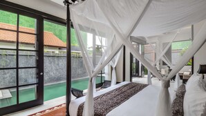 A bedroom with a four-poster bed, a view of a swimming pool, and a door leading to an outdoor area. - Exclusive Holiday Villa with Private Pool and Staff in Umalas, Bali Villa 2079 (Bali)