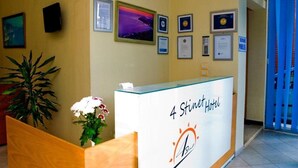 A reception desk with a sign reading "4 Stinit Hotel" and framed certificates on the wall. - 4 Stinet Hotel (Vlorë)