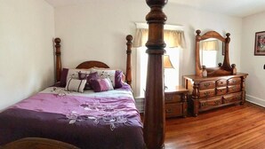 A bedroom with a four-poster bed, wooden dresser, and a mirror. - 3 bedroom/1.5 bath Baseball rental 6 minutes to Cooperstown All star village.  (Oneonta)