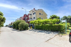 A residential street with multi-story buildings, parked cars, and well-maintained greenery. - VILLA ROSSELLA 1 Two-Bedroom Apartment (Achilea) (Rovinj)