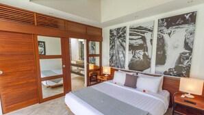 A bedroom with a large bed, wooden wardrobe, and a bathroom visible through a glass door. - Luxury Holiday Villa in Seminyak for Less Than a Hotel, Bali Villa 1146 (Bali)