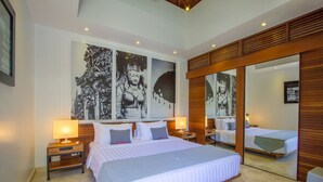 A modern hotel room with a large bed, two bedside tables with lamps, and a large mirror reflecting the room. - Luxury 2-Bedroom Villa Near Seminyak's Attractions, Bali Villa 1147 (Bali)