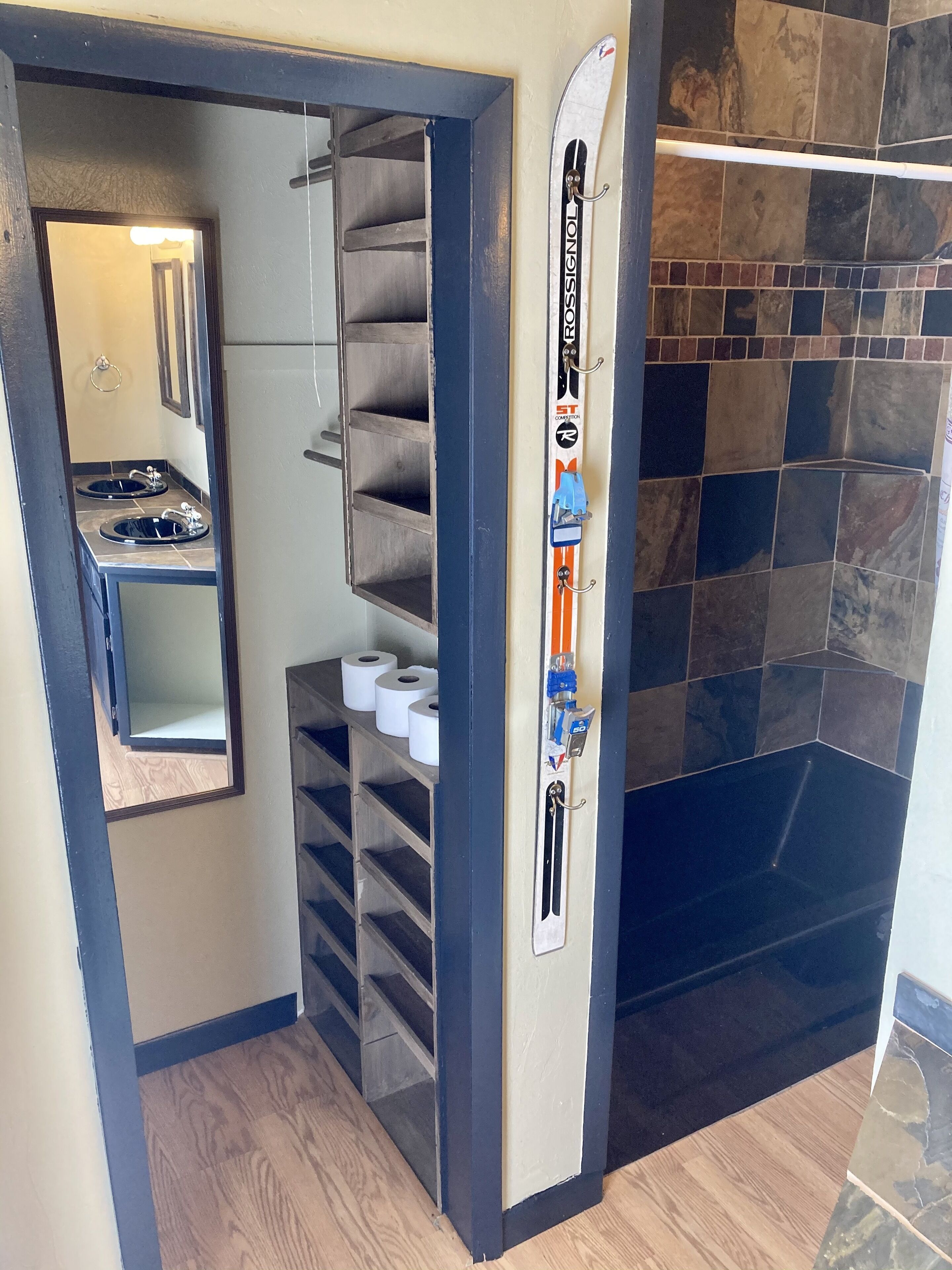 A compact bathroom with a shower, a toilet, and a sink.
