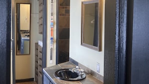 A bathroom with a vanity, a mirror, and a sink. - The Heart of Fraser (Fraser)