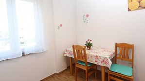 A small dining area with two wooden chairs and a table covered with a floral tablecloth. - GABRIEL One-Bedroom Apartment 3 (Rovinj)