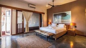 A spacious bedroom with a large bed, a ceiling fan, a view of the sea, and a balcony with sliding doors. - Luxury 5BR Family Villa Near Seminyak, Bali Villa 1167 (Seminyak)