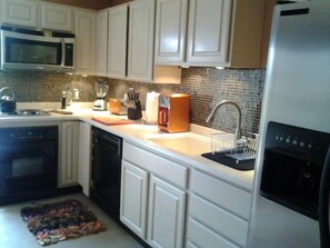 Fridge, microwave, stovetop, coffee/tea maker