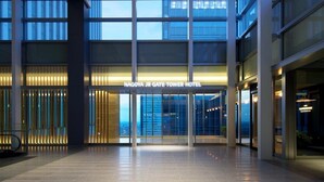 The entrance of Nagoya JR Gate Tower Hotel with a modern design, large glass windows, and a well-lit interior.