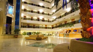 A multi-level hotel lobby with a reception desk, seating areas, and a glass floor. - Perre Delta Hotel (Alanya)