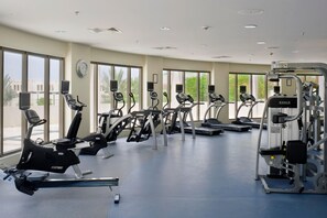 A gym with stationary bikes, treadmills, and weight machines. - Crowne Plaza Sohar (Sohar)