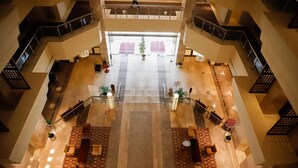 A spacious lobby with a central seating area, multiple staircases, and a large entrance. - Crowne Plaza Sohar (Sohar)