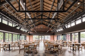 A spacious indoor dining area with high ceilings, exposed beams, and large windows. - The Moment Hotel Yilan by Lakeshore (Wujie)