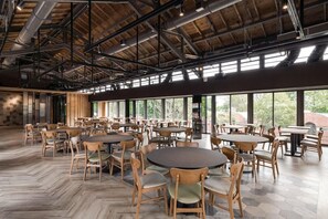 A spacious indoor dining area with multiple tables and chairs, large windows allowing natural light, and a high ceiling with exposed beams. - The Moment Hotel Yilan by Lakeshore (Wujie)