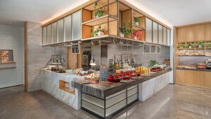 Un bar à petit-déjeuner moderne, proposant une variété d’aliments et agrémenté de plantes.