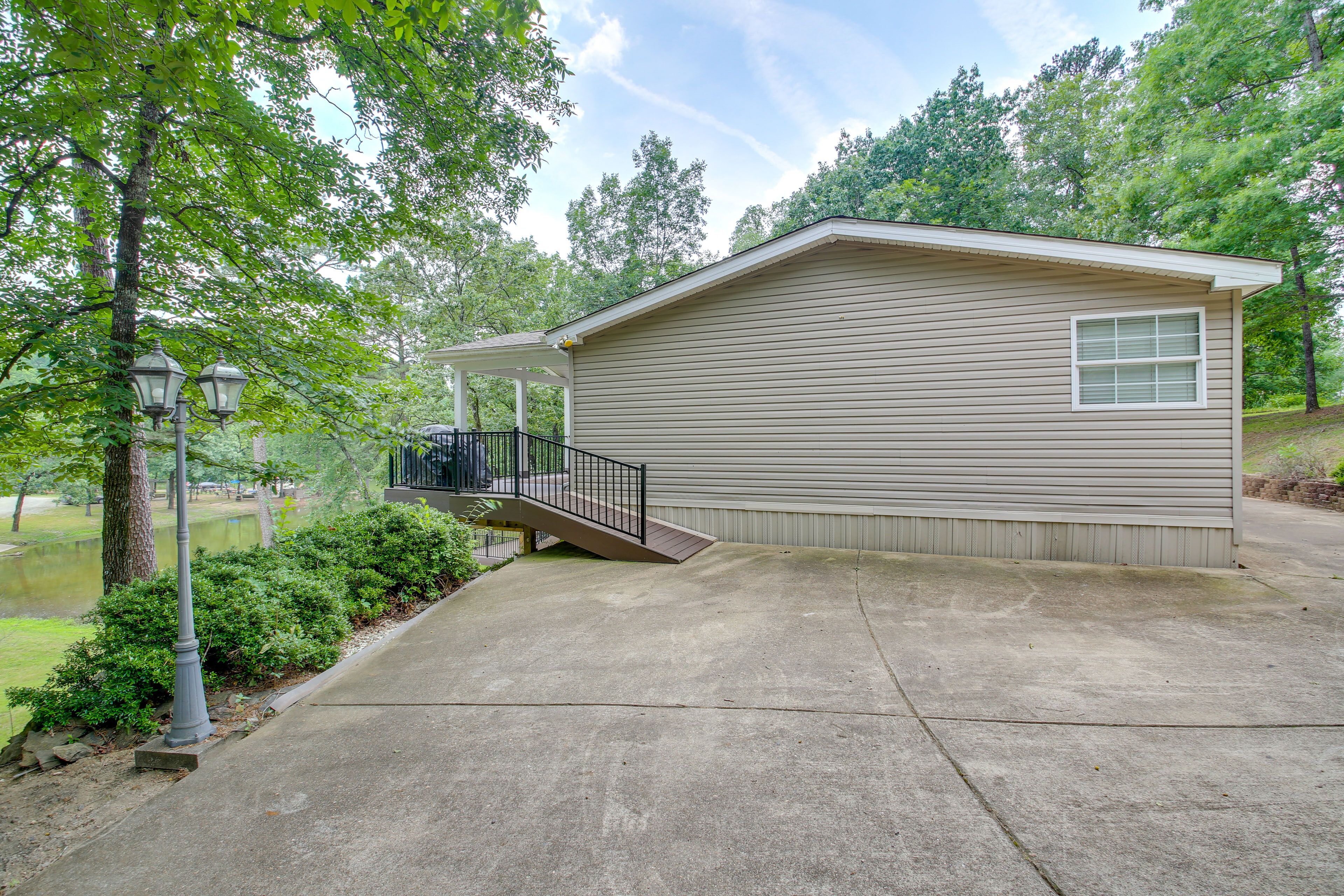A single-story house with a covered porch and a small deck.