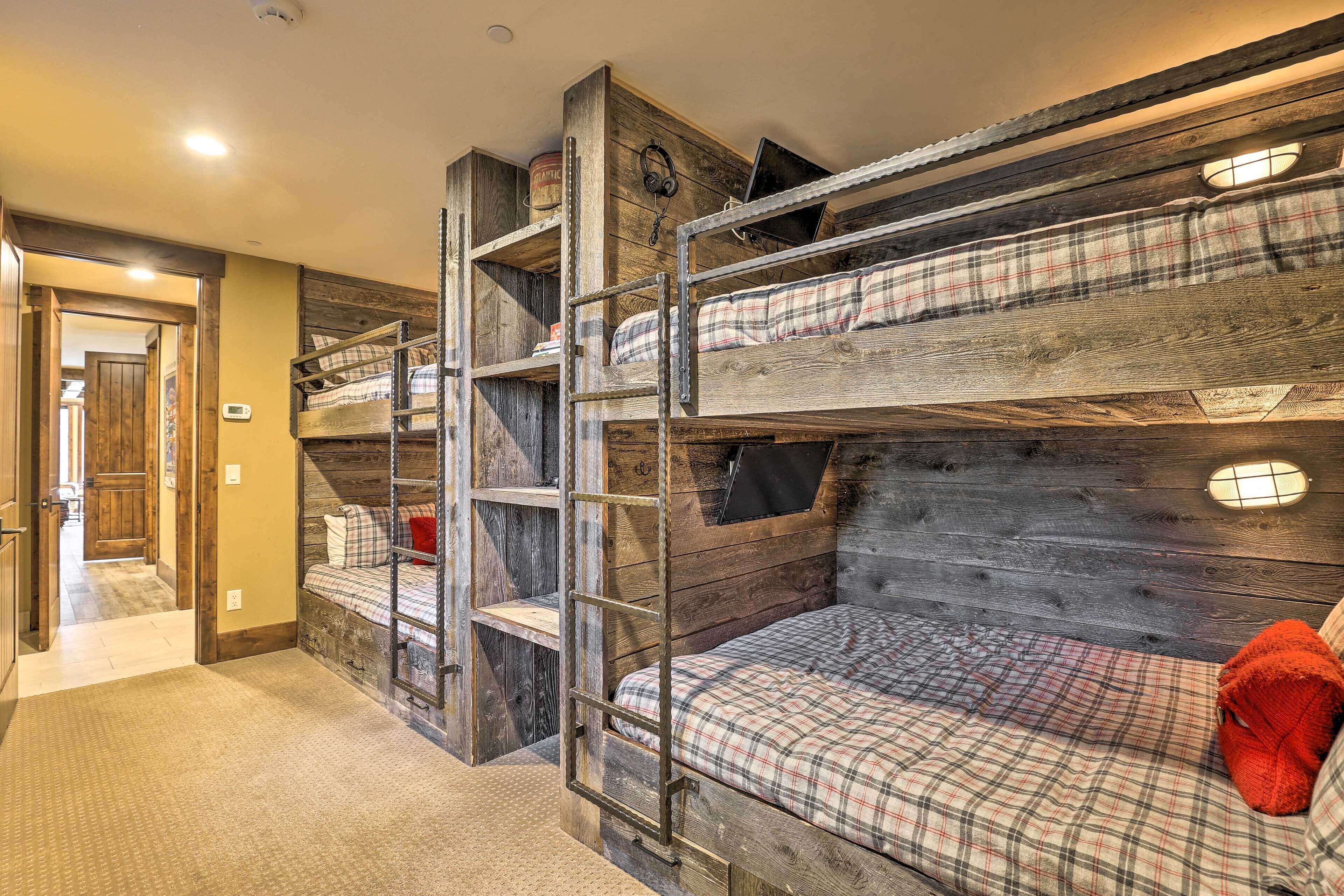 A bunk bed room with wooden walls and a ladder.