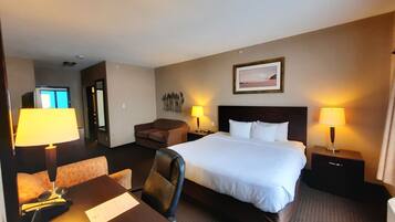 Comfortable retreat with a neatly made bed, desk, and large window.