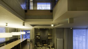 A modern interior with a dining area, seating, and a fireplace.