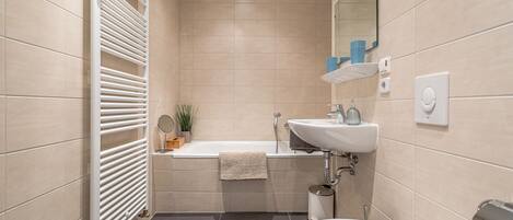 Bathtub, hair dryer, towels, soap