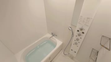 A modern bathroom with a bathtub, a shower with control panel, and a towel rack.