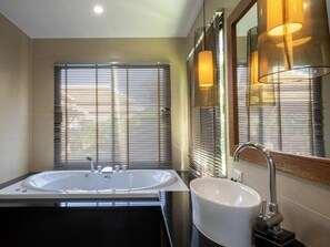 A modern bathroom with a large bathtub, a sink, and a mirror. - Empylean Modern Thai Villa (Rawai)