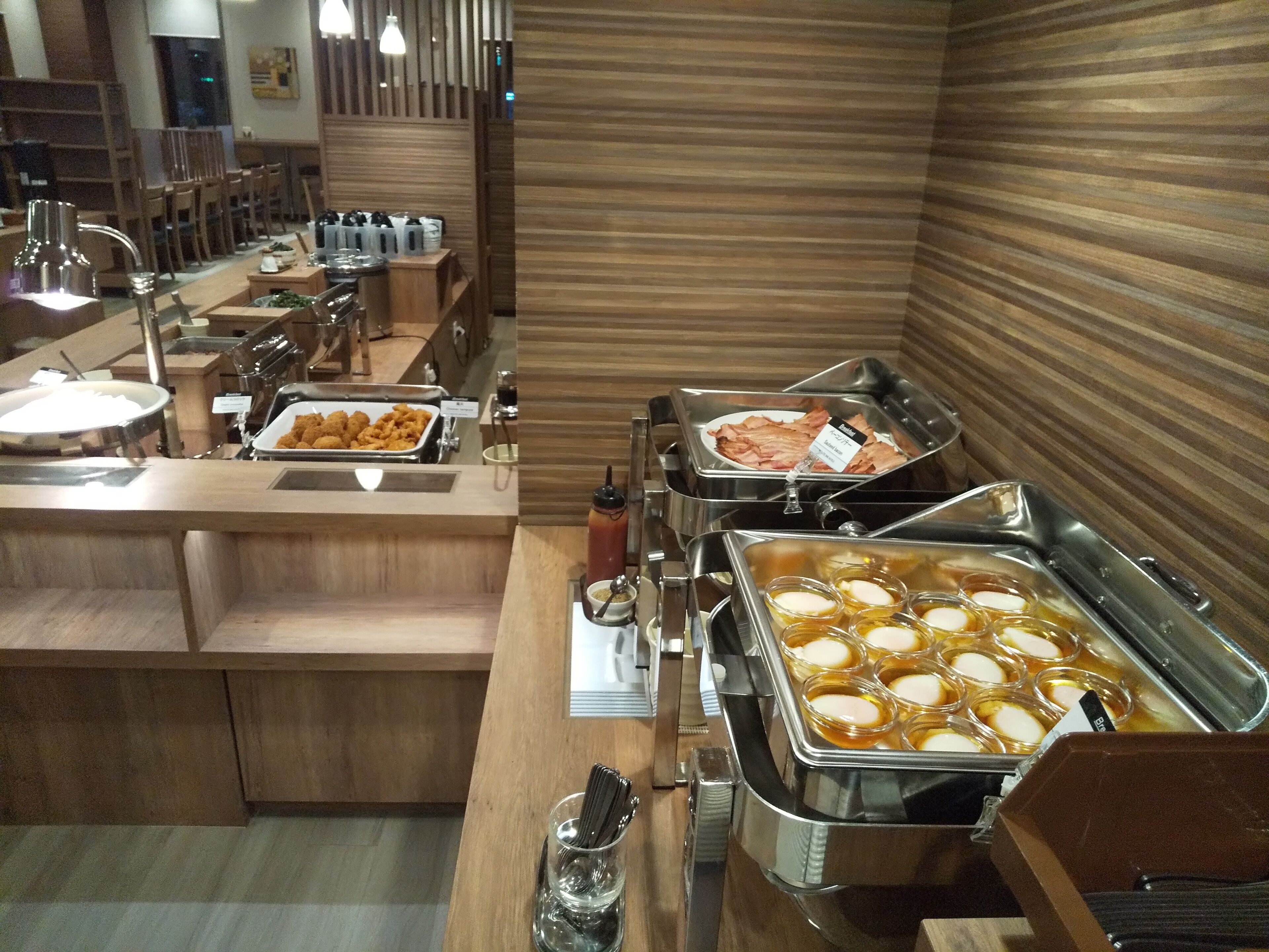 A buffet setup with various food items and condiments.