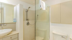 A bathroom with a glass-enclosed shower, a white sink, and a toilet. - Luxury 2 Bedroom With Roof Deck and Pool Dewaterkant (Cape Town)