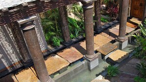 A courtyard with stone columns, a water feature, and tropical plants. - Relax by Your Private Pool, San Jose Del Cabo 1041 (San Jose Del Cabo)