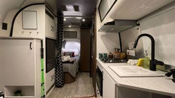 Fridge, microwave, coffee/tea maker, cookware/dishes/utensils