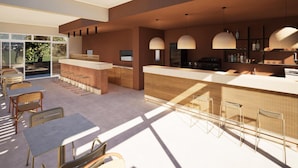 A modern bar area with a long counter, bar stools, and pendant lighting. - Kalloudis Apartment (Kos)