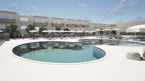 A modern resort with a central pool area, outdoor seating, and a multi-story building in the background. - Kalloudis Apartment (Kos)