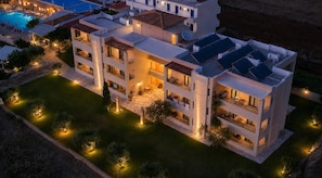 A multi-story hotel with balconies, a swimming pool, and solar panels. - Golden Bay Apartments-garden Haven (Hersonissos)