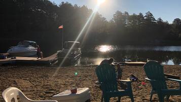 Ranta lähistöllä, aurinkotuoleja, rantapyyhkeitä