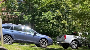 A wooden staircase leading to a vehicle parked on a grassy area. - Cozy Cabin Getaway - Convenient to 4 Ski Areas, Hiking and Mountain Bike Trails (Davis)