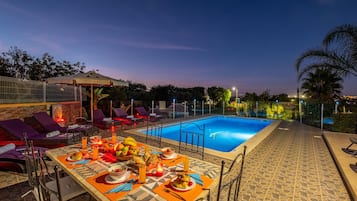 A heated pool, pool loungers