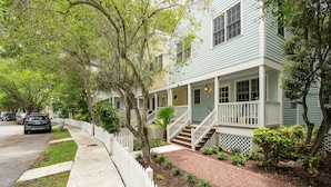 A row of light green two-story houses with white railings and a brick pathway. - Fairway Villa w/ Private Pool  (Key West)