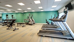 A gym with treadmills, ellipticals, and weight machines.