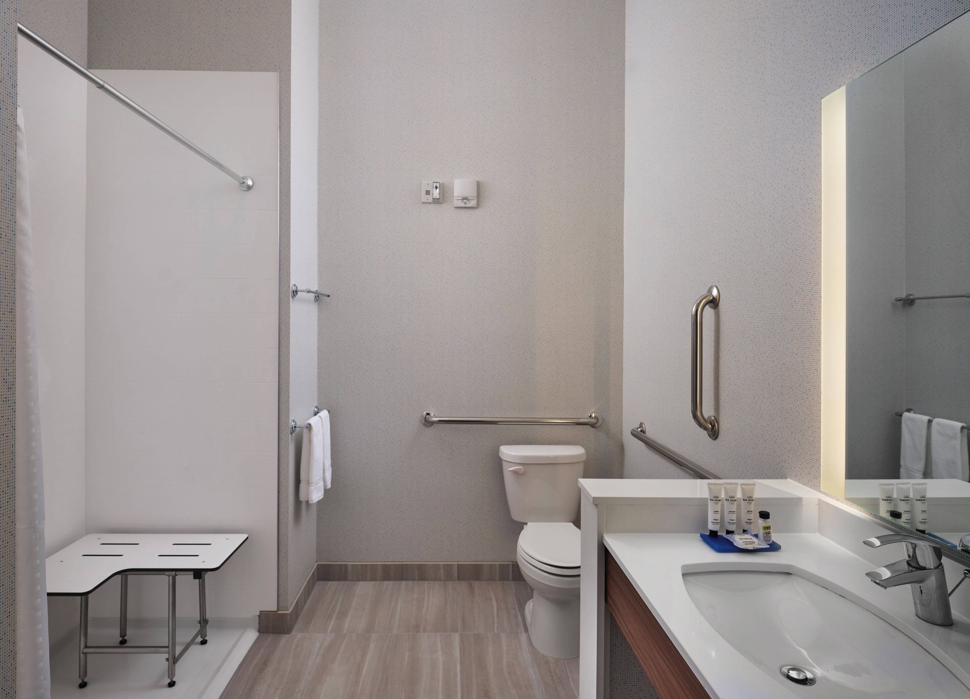 Une salle de bain moderne équipée d’une douche, de toilettes et d’un lavabo.