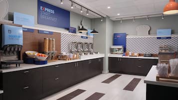 A modern breakfast area with a coffee machine, fruit bowl, cereal containers, and a bakery section.