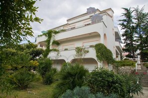 Stunning building with lush greenery and decorative balconies.