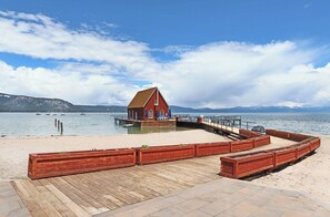 Relax by the serene lake with a picturesque view of the surrounding mountains.