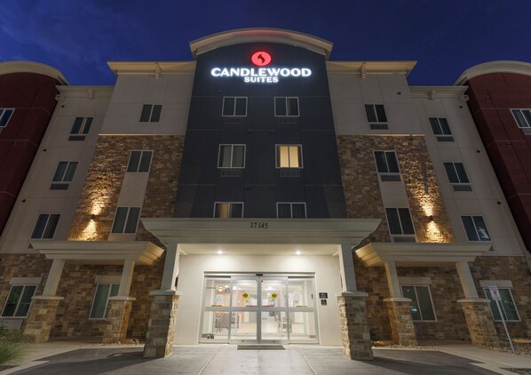 A hotel entrance with a modern design, featuring a prominent sign for Candlewood Suites. - Candlewood Suites San Antonio - Schertz (Schertz)