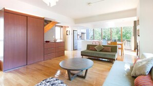 A spacious living area with a sofa, a coffee table, and a wooden cabinet. - Luxury 3 Bed Ski Chalet in Prime Location, Niseko Chalet 1001 (Niseko)