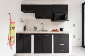 Fridge, microwave, coffee/tea maker, cookware/dishes/utensils